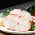 Raw red rockfish steaks with white flesh on a white plate